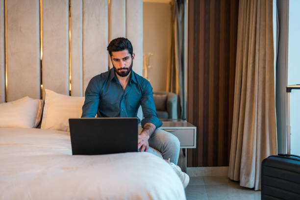 istock Focused Young Arabic Businessman in Modern Hotel Room 2194497572