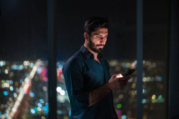 istock Young Arabic Man Engaged with Smartphone in Modern Riyadh Apartment 2194497711