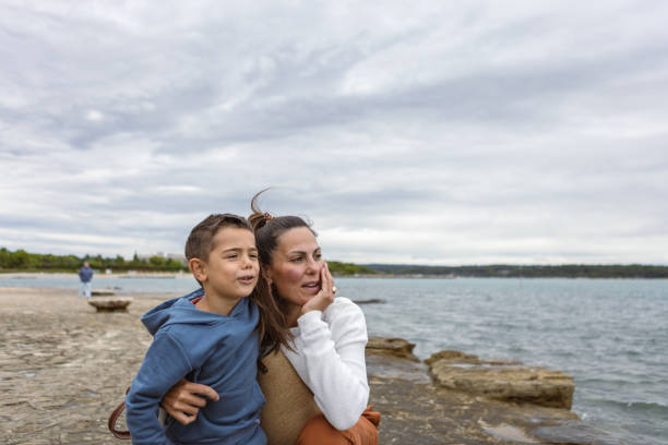 istock Happy Mother and Son Enjoying Lakeside View Together 2194497962