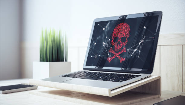 istock Digital skull warning displayed on a laptop screen in office setting on wooden desk. 3D Rendering 2194499031
