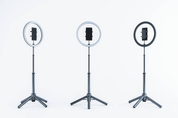 istock Adjustable ring lights with smartphone holders on tripods, isolated on a light background. 3D Rendering 2194499086