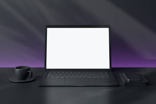 istock Modern laptop with blank screen and smartphone on desk, with coffee cup, against abstract dark background. 3D Rendering 2194499487