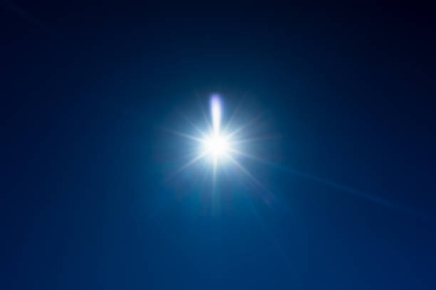 istock Lens flare effect of the Sun over deep blue sky 2194499799