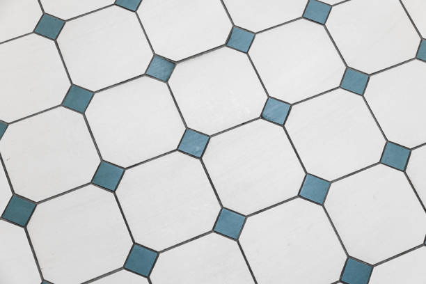 Vintage stone mosaic floor tiling with white and green squares pattern, background photo texture