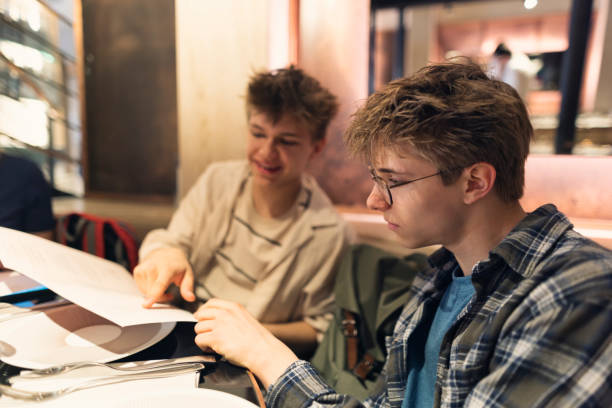 istock Teenagers reading menu in a restaurant 2194502316