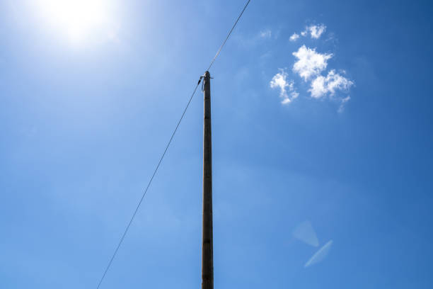 Wooden pole with telephone wire in the countryside