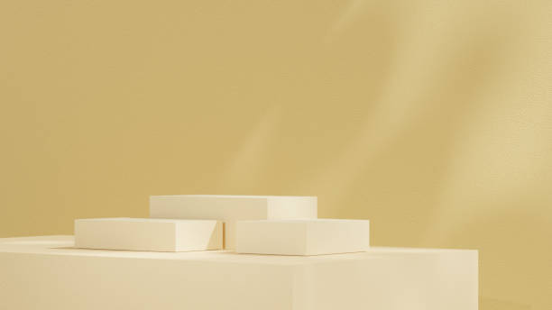 istock Product display stands, along with a podium, are set against a yellow background with soft, subtle shadows in a landscape orientation. 2194503590