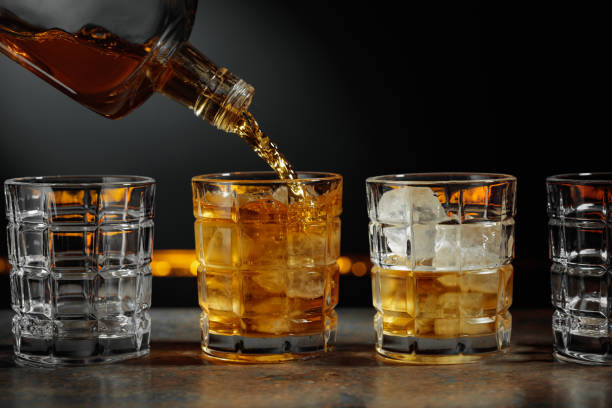 istock Whiskey is poured into a glass with ice. 2194507097
