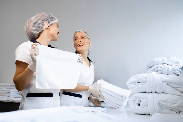 istock Female workers folding clean laundry and preparing for delivery. 2194507160