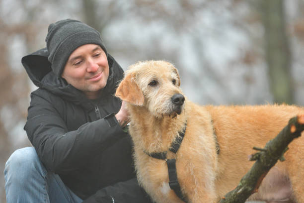 istock Man and Dog Bonding in Misty Forest with Soft Light 2194508561