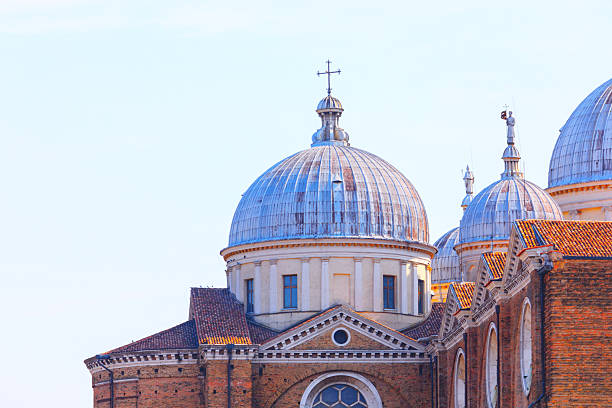 Ancient cupola of Padua Cathedral, Veneto, Italy. Building featuring two prominent domes, impressive architectural design against a clear sky