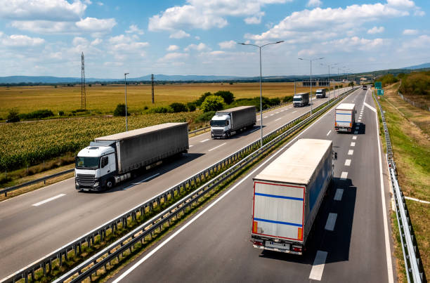 istock Transportation Trucks in lines passing 2194508808