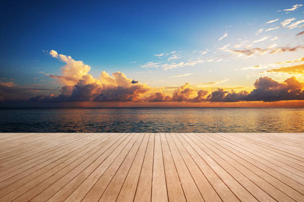 istock Empty wooden sea view terrace with dramatic sky and colorfull clouds during the sunset 2194511180