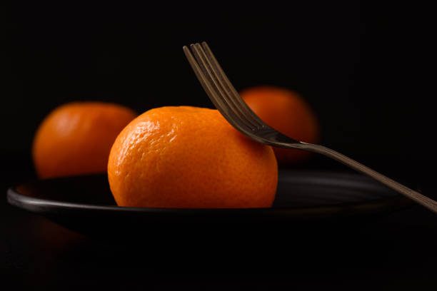Fresh mandarin oranges healthy fruit on black background.