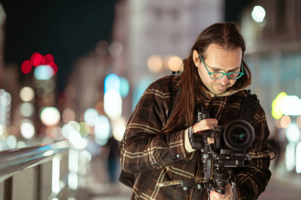 istock Cameraman using gimbal in street at night. 2194519278