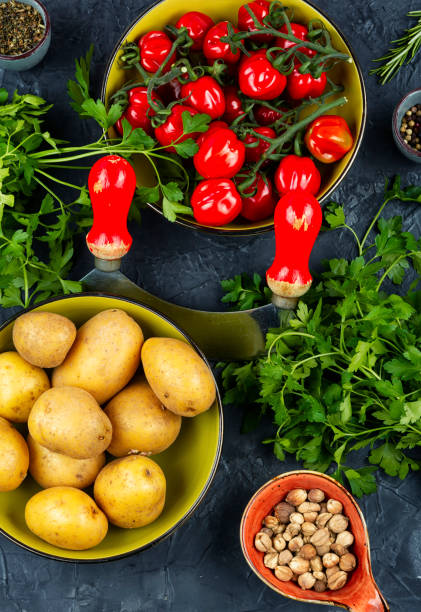 istock Raw potato and red tomatoes on a table 2194519679