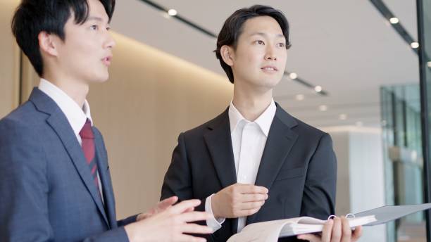 istock Businessmen holding drawings and having a meeting 2194519901