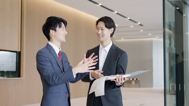 istock Businessmen holding drawings and having a meeting 2194519902