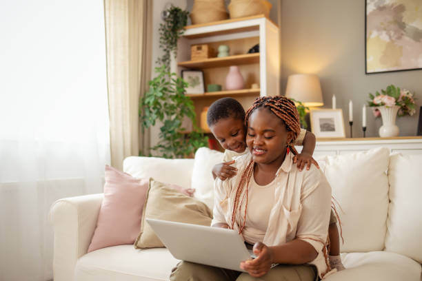 istock Black Mother and Son Having Fun While Using a Laptop Together 2194522394
