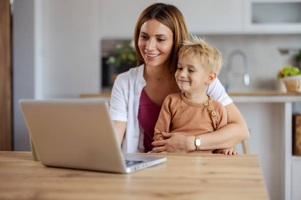 istock Joyful Mom and Son Having Fun Together Using a Laptop 2194522401