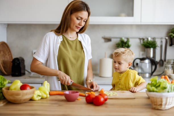 istock Fun Family Time: Young Mom and Her Little Boy Cooking Together 2194522412