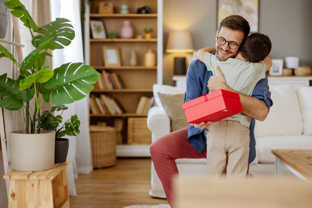 istock Joyful Son Giving His Dad a Gift Box While Hugging and Smiling on Father’s Day 2194522468