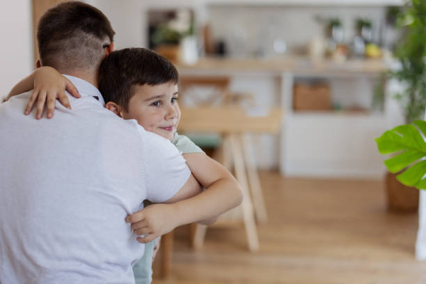istock Father and Son Bonding Moment: A Joyful Hug in a Cozy Home Setting 2194522469