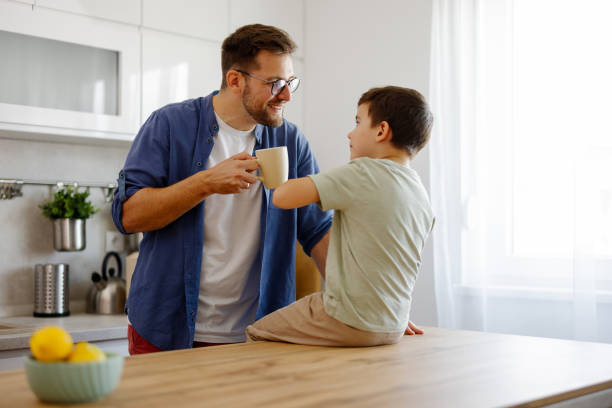 istock Father and Son Sharing a Joyful Conversation in the Kitchen 2194522491
