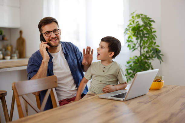 istock Multitasking Father Working from Home While Taking Care of His Little Son 2194522561