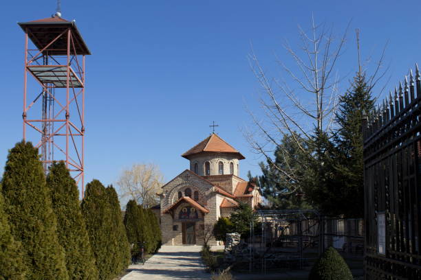 istock Beautiful church surrounded by trees and a tower on a clear day 2194524100
