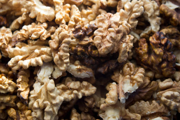 istock Nuts scattered on a table show their rich textures and shapes in a bright, natural light during daylight hours 2194524101