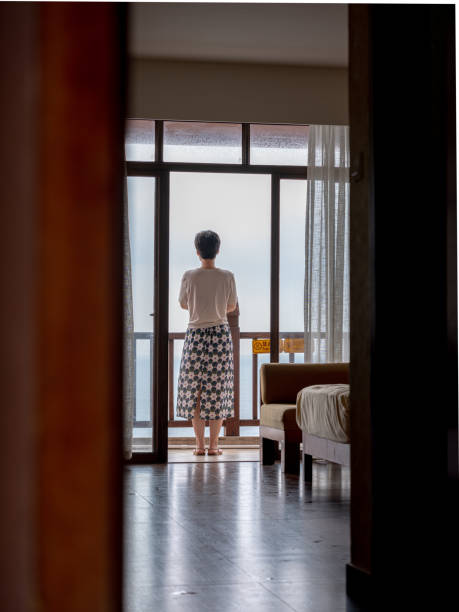 istock Woman on balcony overlooking ocean 2194524245