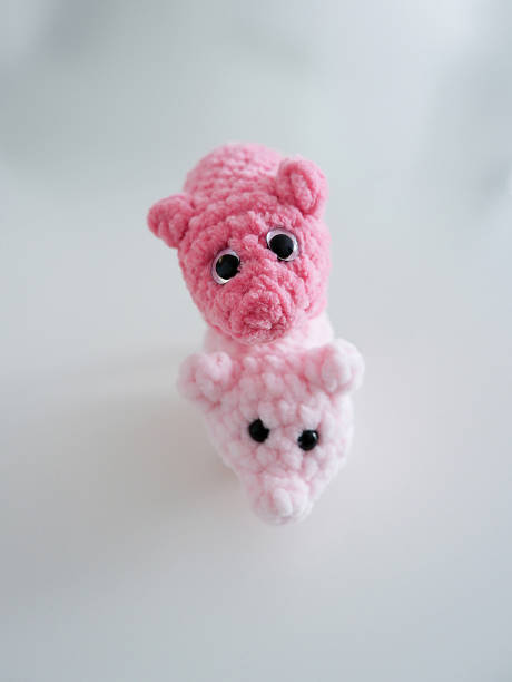 istock two cute little piggy crocheted by hand from wool. 2194525777