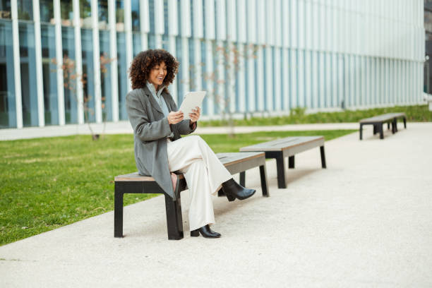 istock Latin businesswoman taking a break outdoors and using tablet 2194525968