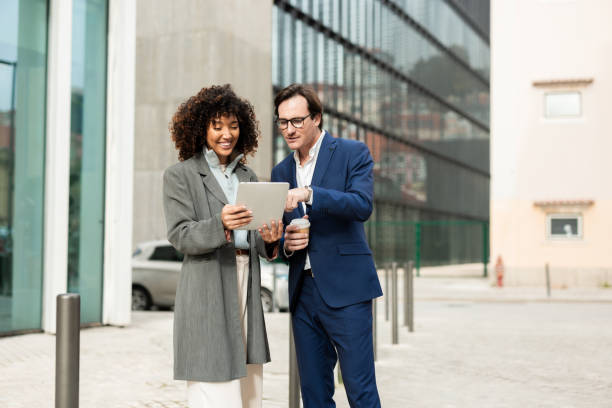 istock Couple of colleagues enjoying a break and using tablet 2194525977