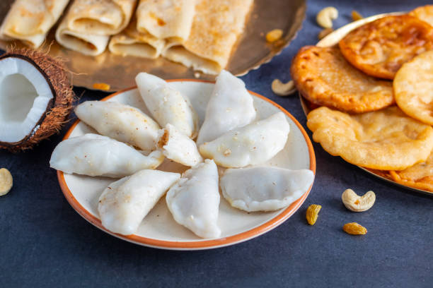 Pitha pulli is a traditional Bengali dish featuring rice flour dumplings stuffed with jaggery, coconut, and sometimes nuts.