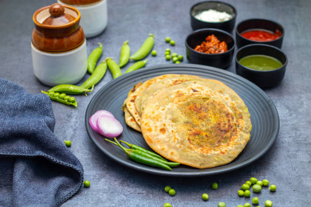 istock Matar paratha is a delicious Indian flatbread stuffed with spiced mashed green peas, cooked until golden and served with chutney. 2194527161