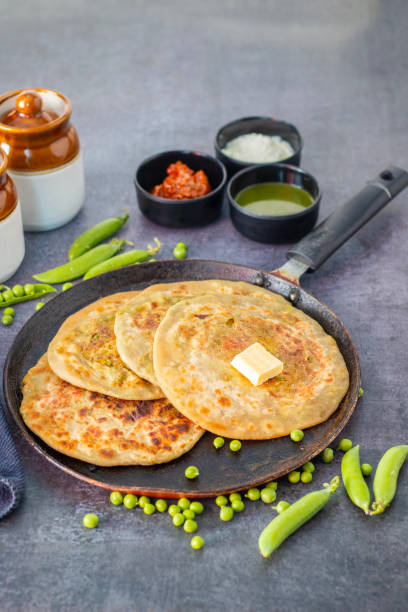 istock Matar paratha is a delicious Indian flatbread stuffed with spiced mashed green peas, cooked until golden and served with chutney. 2194527414