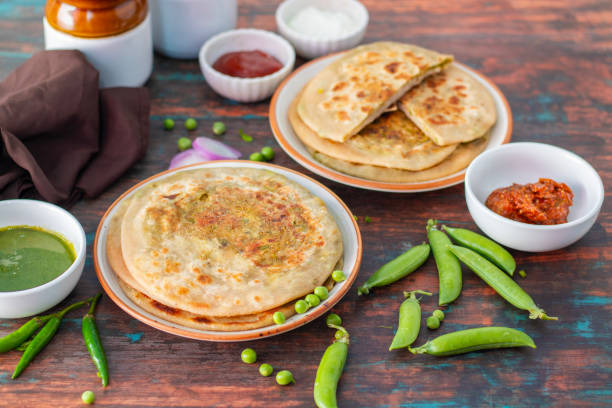 istock Matar paratha is a delicious Indian flatbread stuffed with spiced mashed green peas, cooked until golden and served with chutney. 2194527602