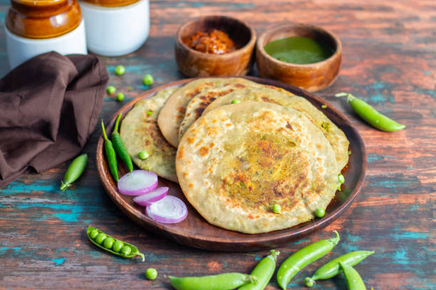 istock Matar paratha is a delicious Indian flatbread stuffed with spiced mashed green peas, cooked until golden and served with chutney. 2194527747