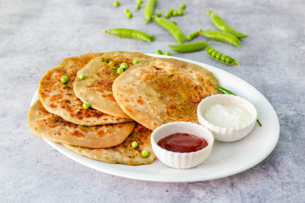 istock Matar paratha is a delicious Indian flatbread stuffed with spiced mashed green peas, cooked until golden and served with chutney. 2194527792