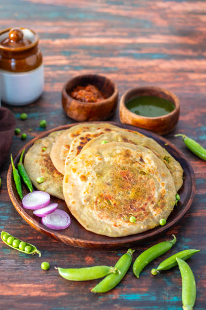istock Matar paratha is a delicious Indian flatbread stuffed with spiced mashed green peas, cooked until golden and served with chutney. 2194527804
