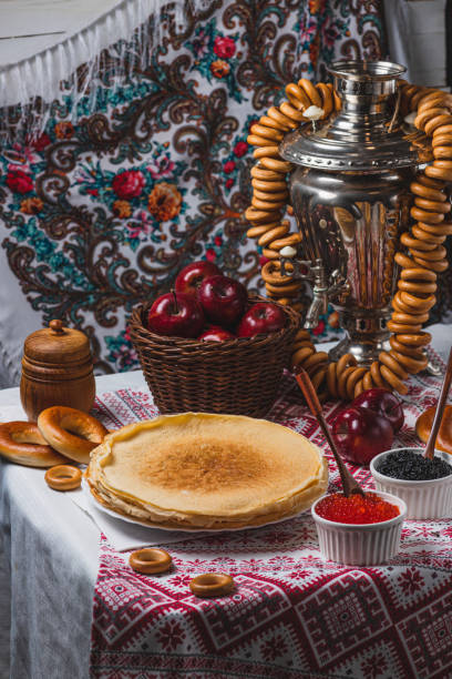 istock Pancakes on the table with traditional patterns, next to the samovar, apples and caviar 2194529141