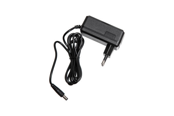 istock A black power adapter with a coiled cable, isolated on a white background, suitable for electronic devices, close-up view. 2194529788