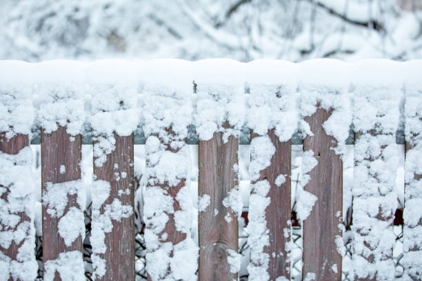 istock Wooden fence covered with thick snow, on winter day, idyllic setting 2194529857