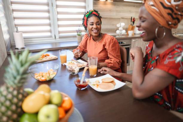 istock Two smiling young women having breakfast in the kitchen 2194541825