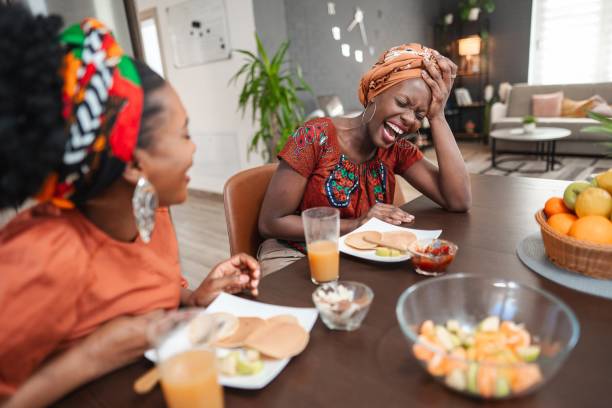 istock Two cheerful black women having fun while eating pancakes at home 2194541914