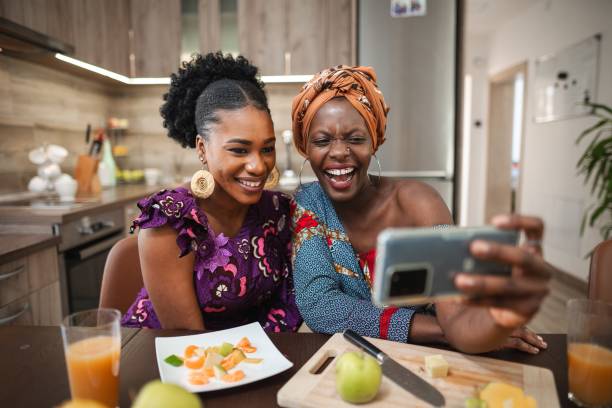 istock Two smiling women taking a selfie while preparing fruit salad in the kitchen 2194541923