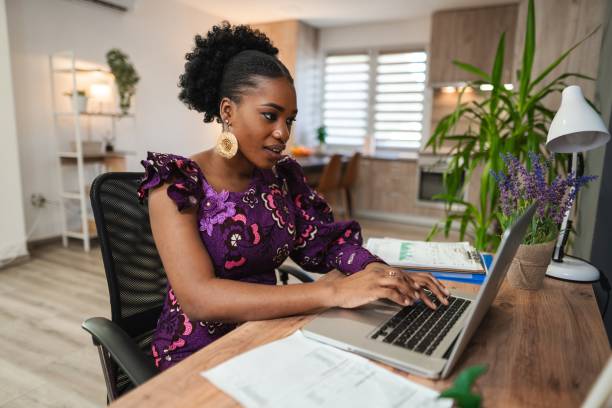 istock Young black woman working from home office using laptop 2194541992