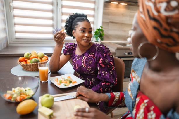 istock Two smiling women preparing fruit salad in the kitchen 2194542021